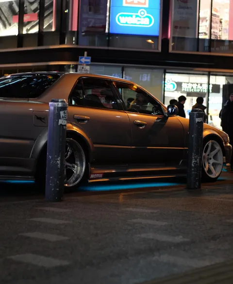 Nissan Skyline R34 under Tokyo neon signs